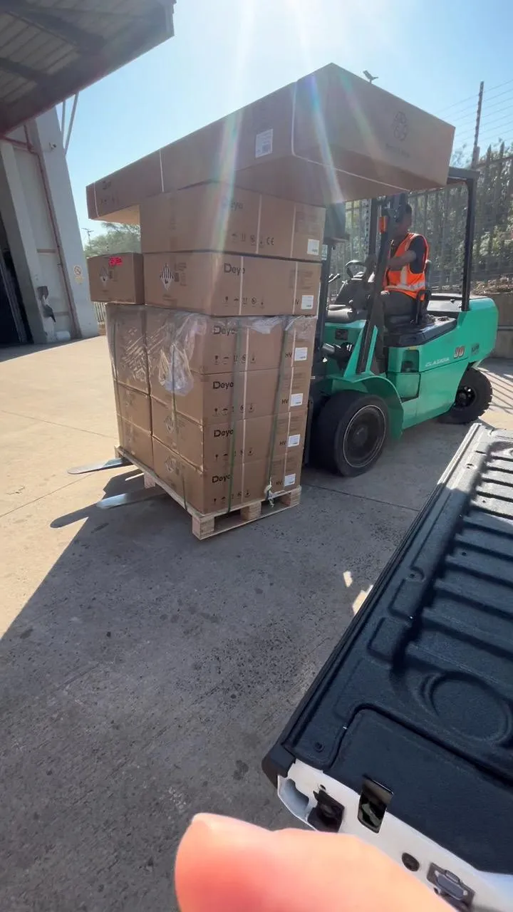 A forklift carrying a strapped pallet of boxed Deye equipment across a warehouse yard