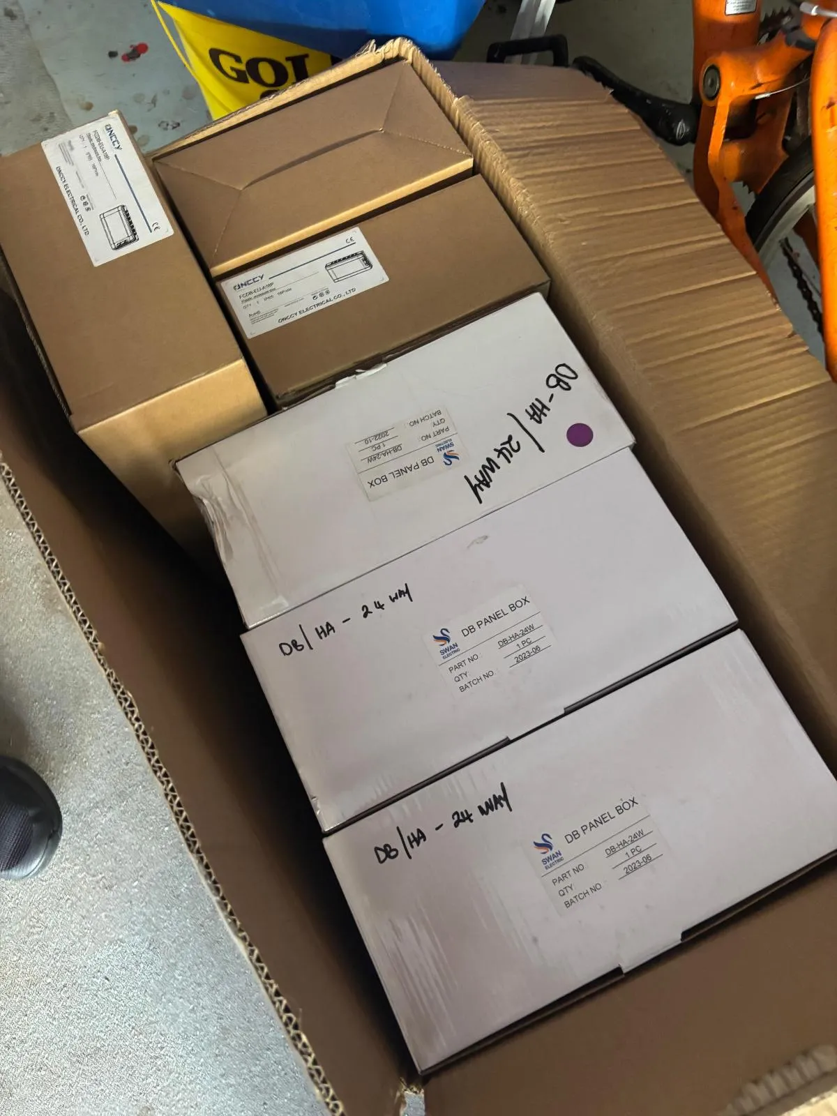 Boxed distribution-board enclosures packed together in a large cardboard carton