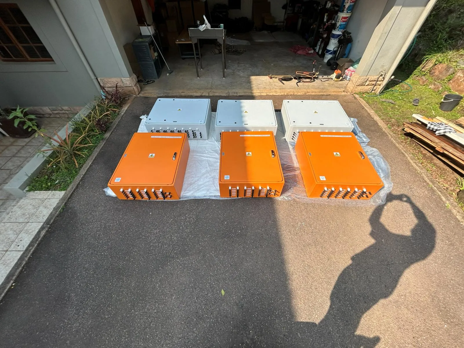 Orange and grey enclosure chassis laid out side by side before assembly.