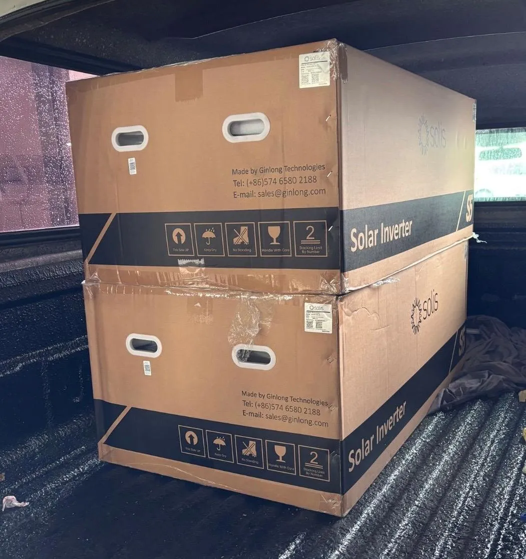 A pair of boxed Solis solar inverters stacked and wrapped in a vehicle load bed