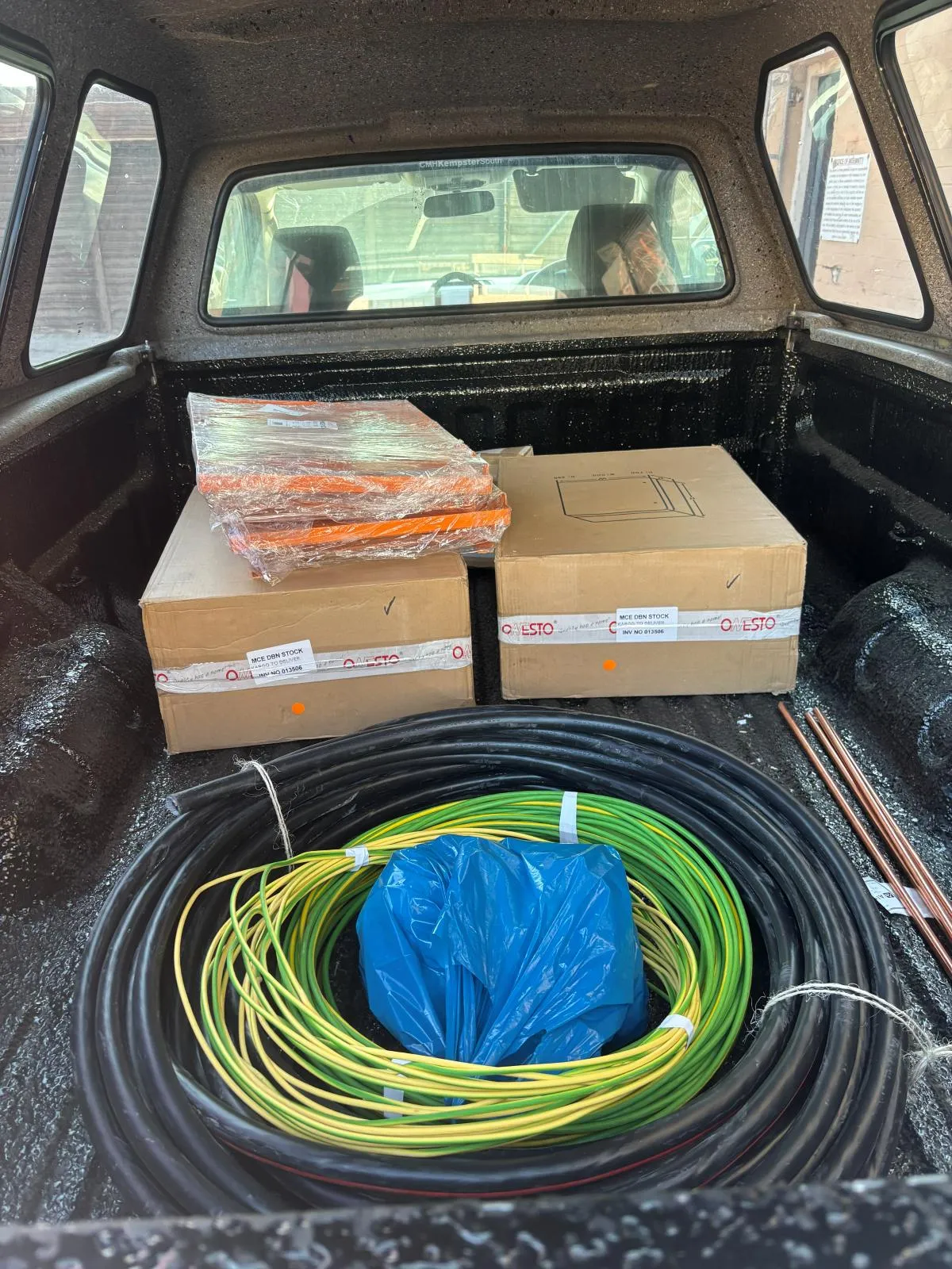 Boxed Onesto switchgear, coiled cable and copper earth rods loaded in a vehicle load bed